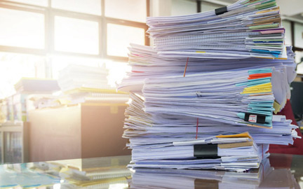 pile of documents for in-site confidential shredding shredding